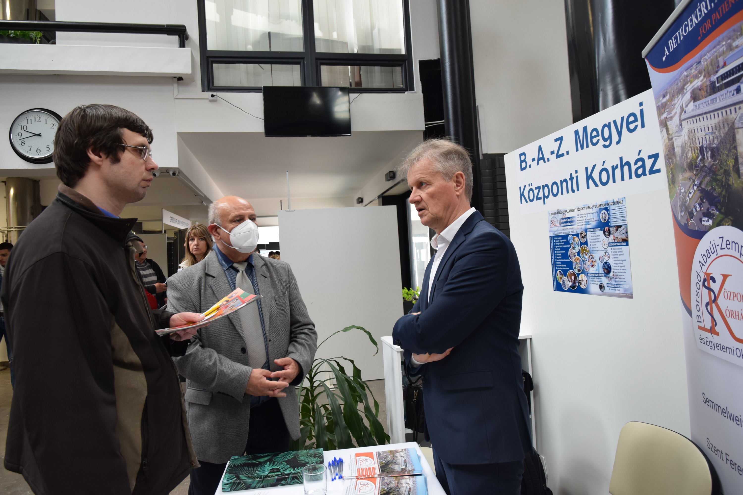 Résztvevők beszélgetnek egy standnál